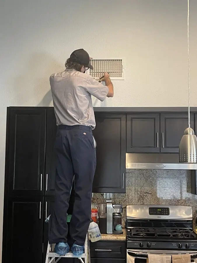 Technician inspecting an air vent during HVAC service in Cherryville